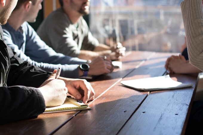 A picture of people sitting around a table